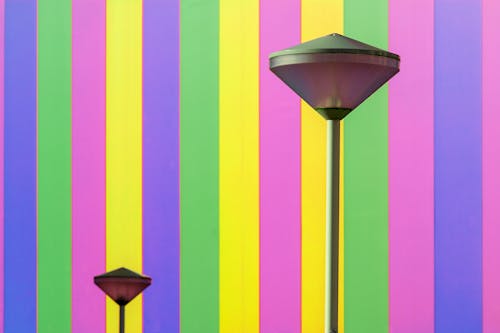 Free A colorful striped wall with two street lamps Stock Photo