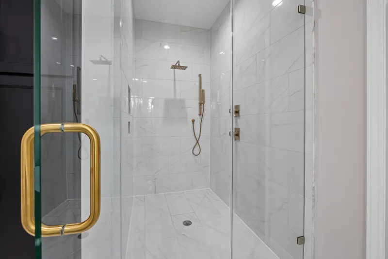 Modern shower with chrome and gold hardware accents
