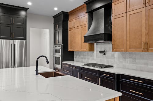 View of a Modern Kitchen with Black and Wooden Cabinets 