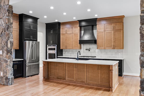 Kitchen with wooden cabinetry and stone accents