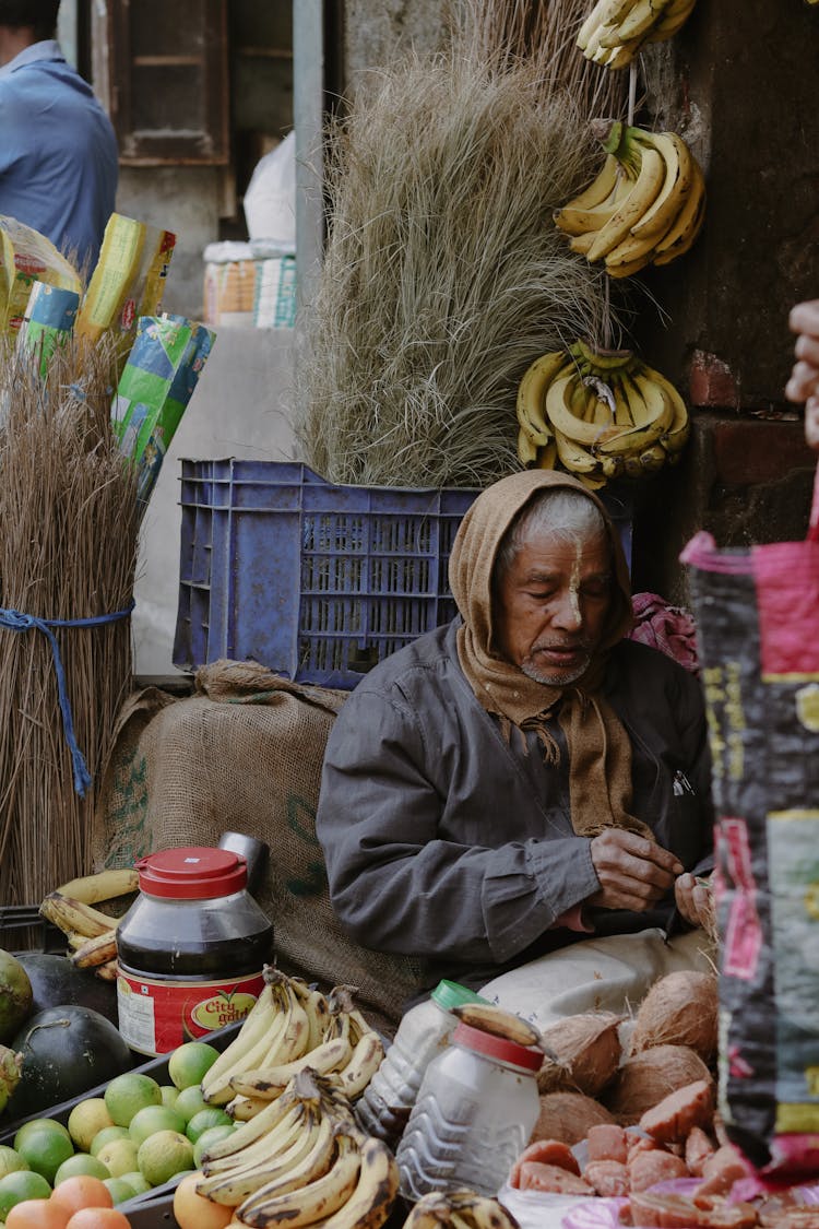 Elderly Man Selling Fruits On A Market 