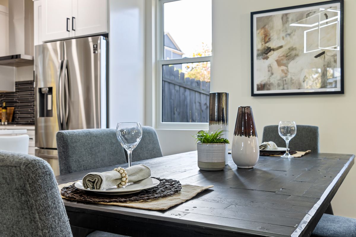 Stylish dining room with table setting and wall décor