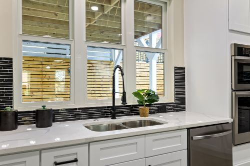 Free Sleek modern kitchen interior with granite countertops and stainless steel appliances. Stock Photo