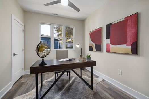 A minimalist home office with modern furniture, globe, and abstract art.