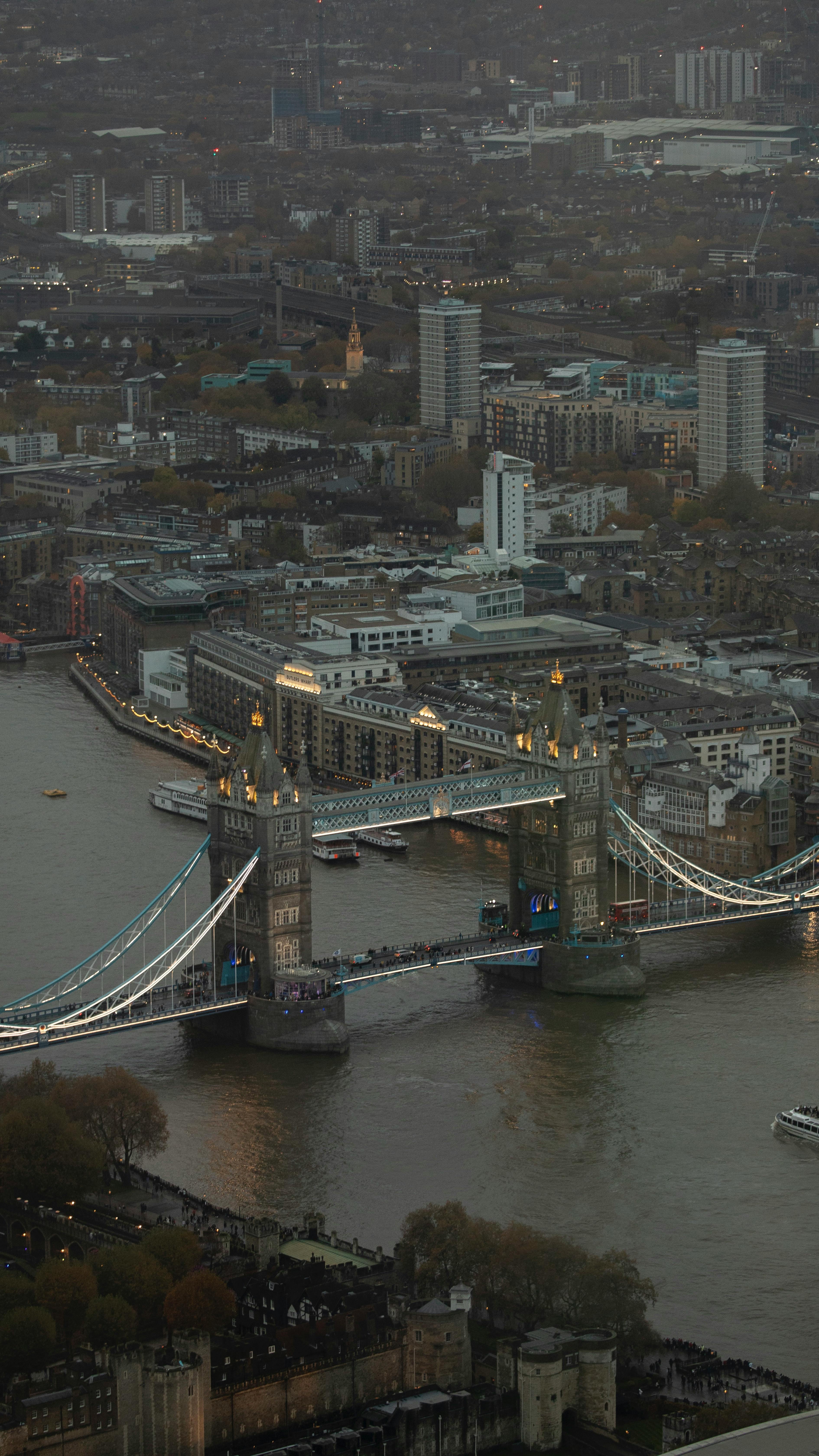 Captivating aerial view of Tower Bridge in London under twilight, showcasing the cityscape.