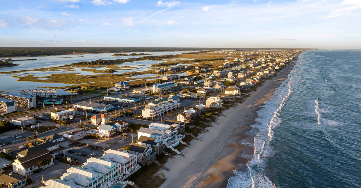 Scenic aerial view of a coastal town with sandy beaches and waves in North Carolina.