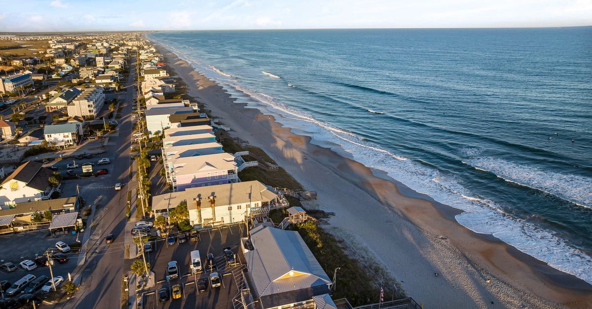 Stunning aerial view capturing Surf City, NC, coastline and beach in vibrant summer light.