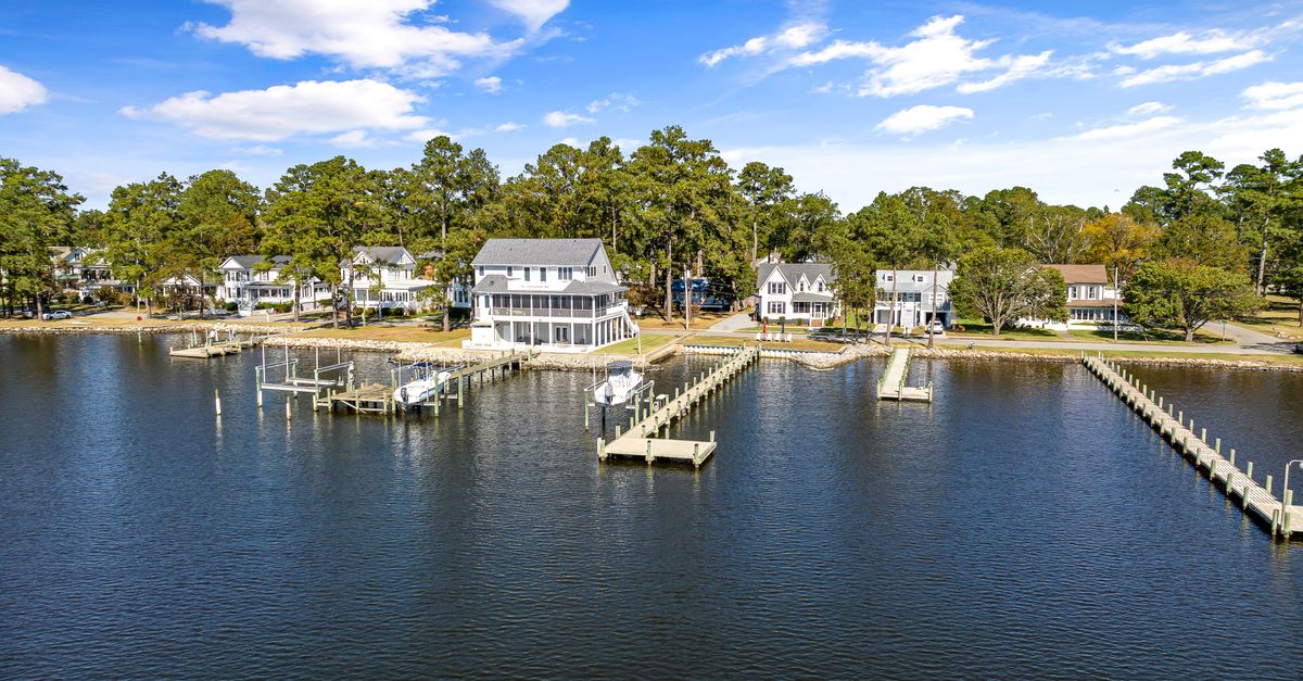 Aerial view of waterfront homes and docks in Belhaven, NC on a sunny day.