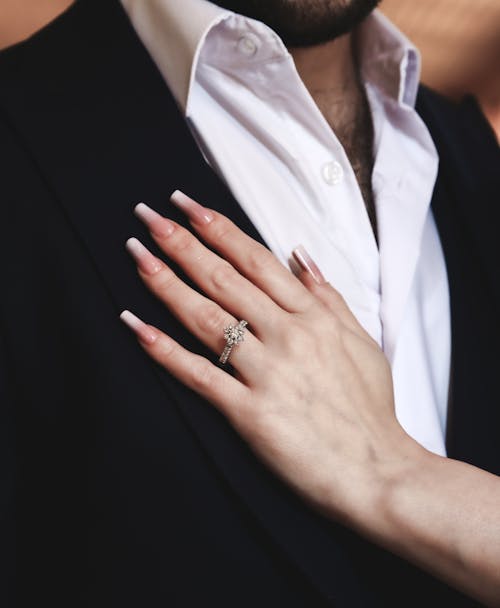 Engagement Ring on a Womans Hand Resting on a Man Chest