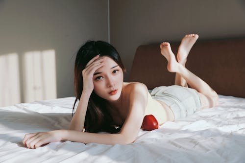 Woman Lying Down on Bed