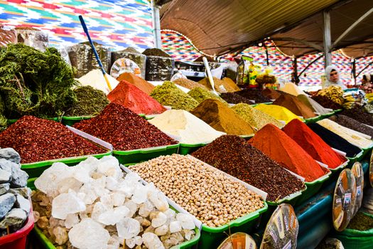 Vibrant display of spices at bazaar market, showcasing variety and color.