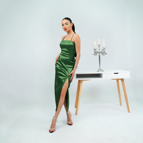 Model Posing in Green Satin Dress