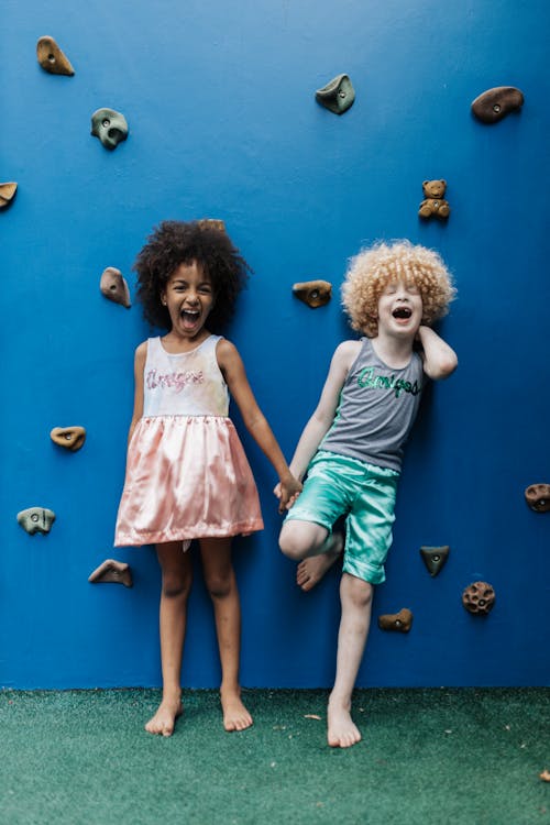 Free A Little Girl and Boy Standing by a Rock Climbing Wall  Stock Photo