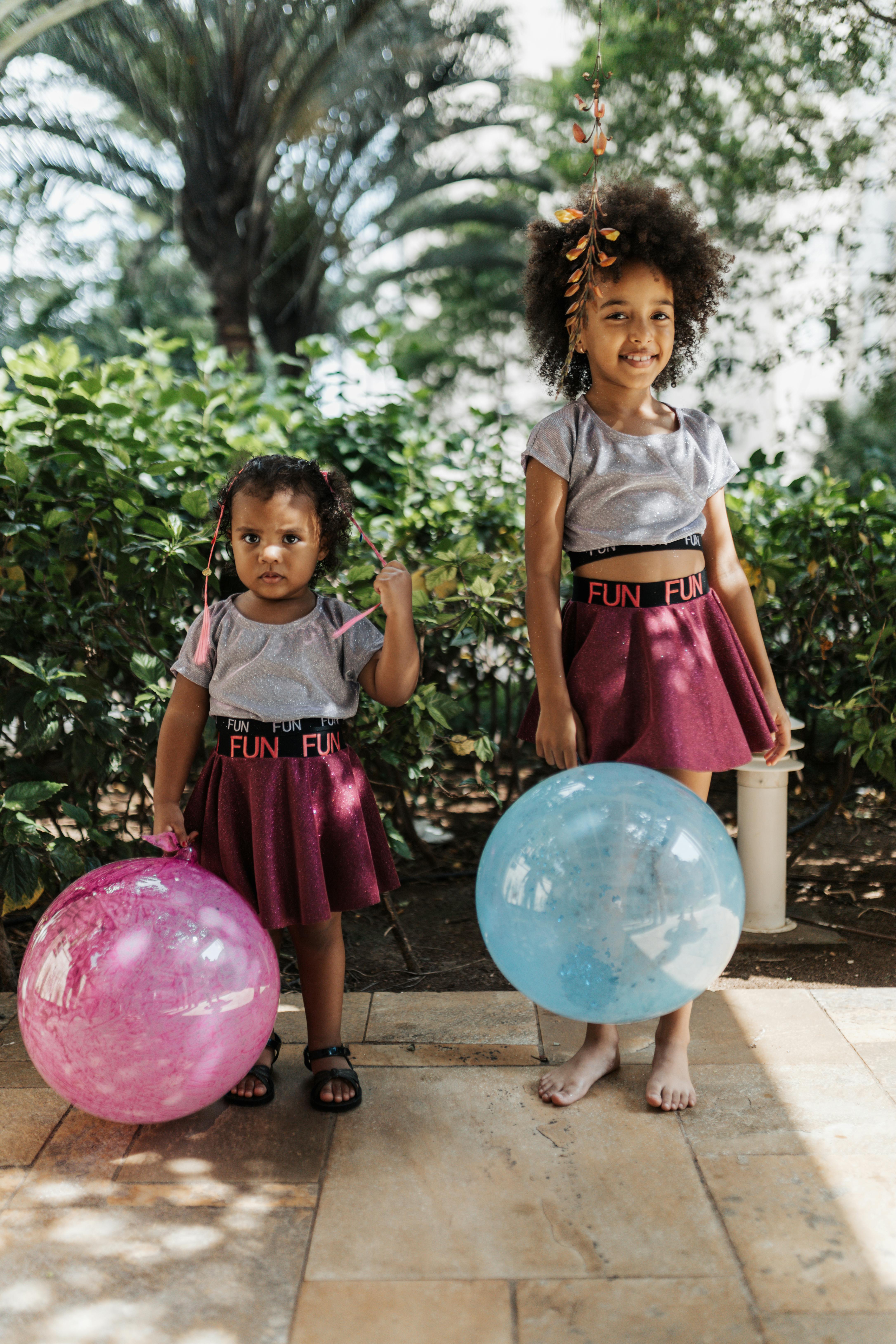 Girls in Matching Clothes with Balloons Free Stock Photo