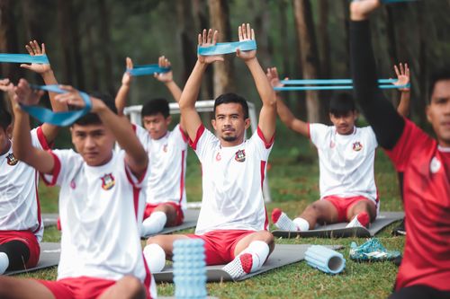 Free A group of young soccer players exercises with resistance bands during outdoor training. Stock Photo