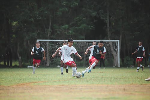 A group of young men playing soccer on a field