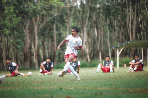 A group of men playing soccer on a field