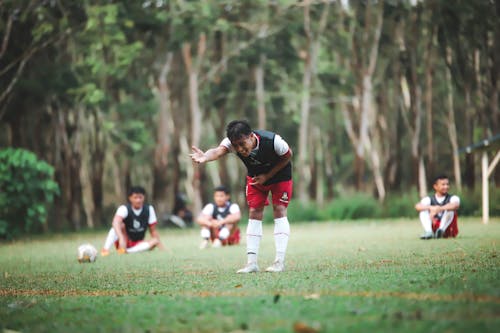 A group of people playing soccer in a field