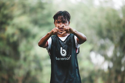 A young boy making a gesture with his hand