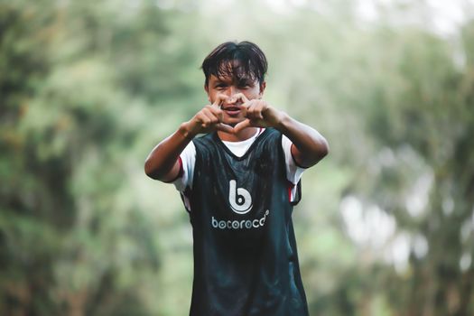 Energetic young soccer player making a gesture on the field, filled with enthusiasm and energy.