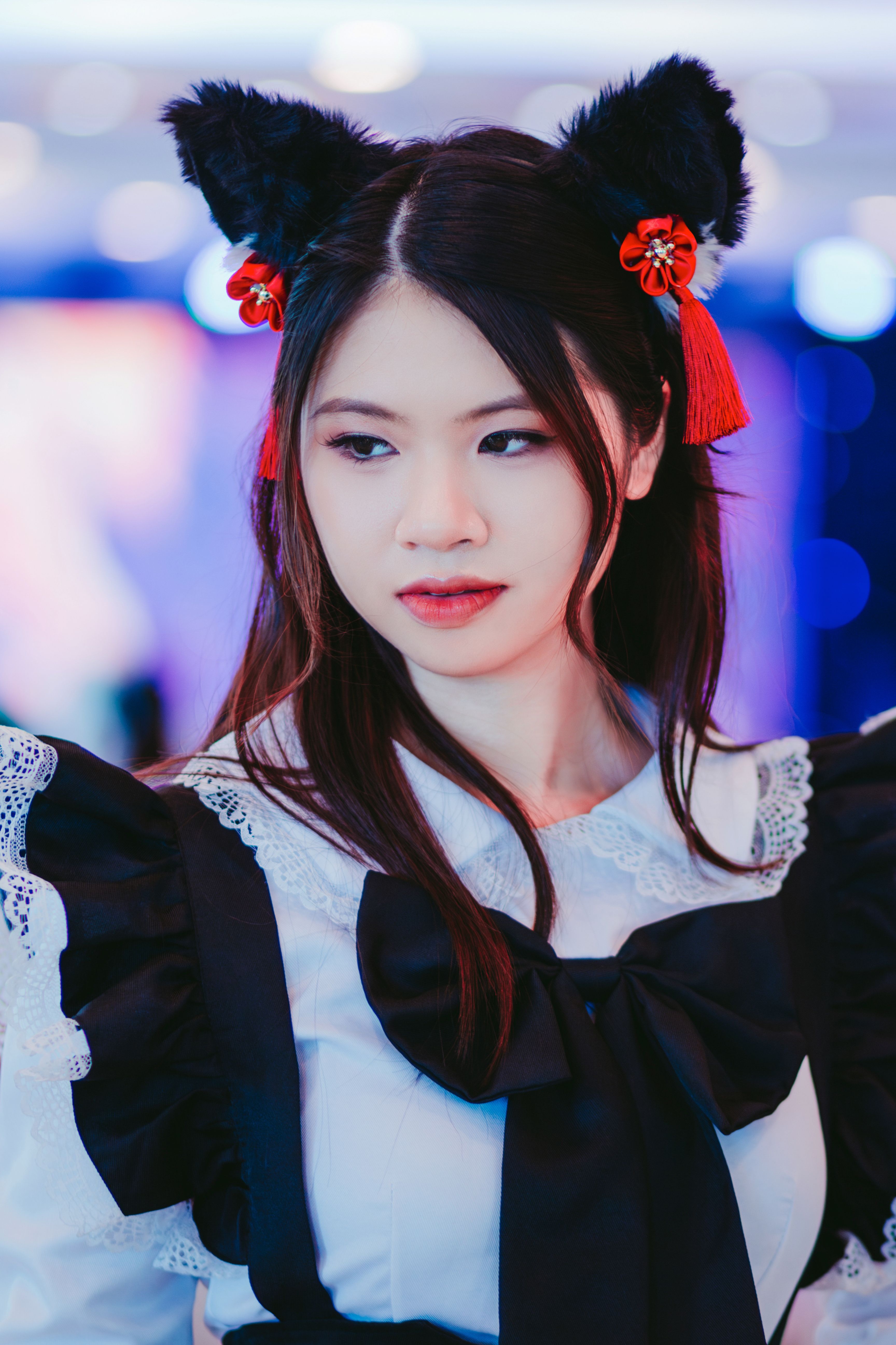 Young Woman Posing in Black and White Manga Cosplay Dress and Cat Ears Headband