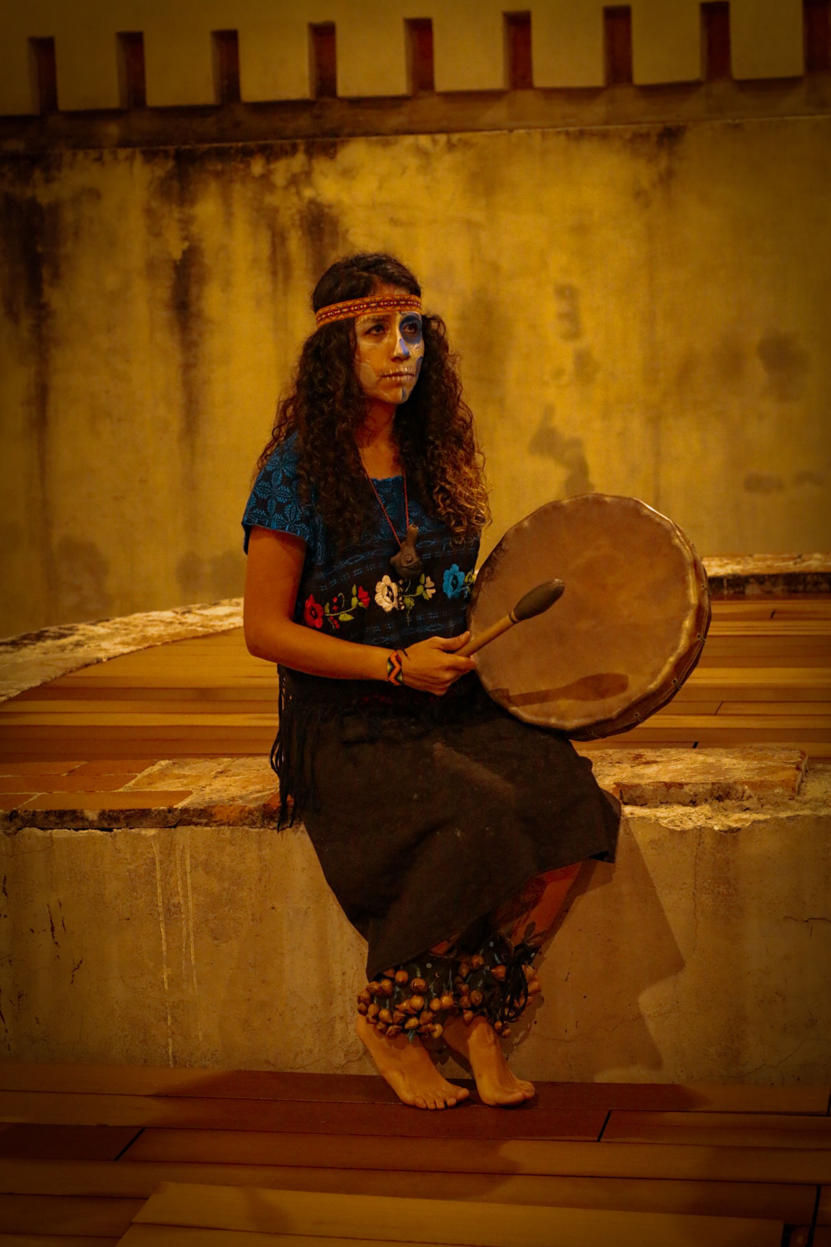 Woman in Traditional Clothing and with Painted Face Sitting with ...