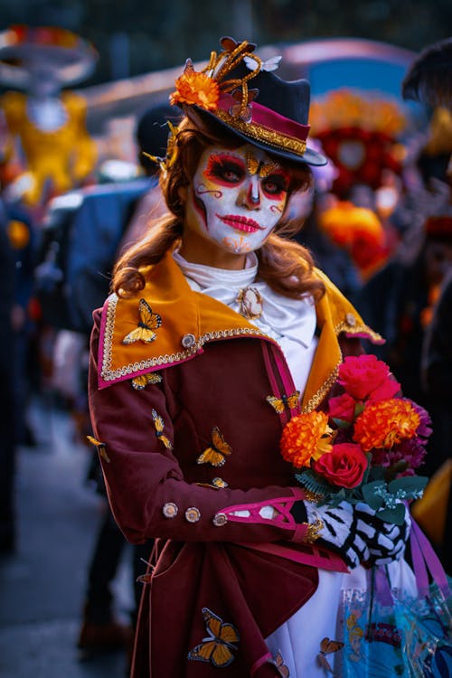 Woman in Traditional Halloween Costume Holding Flowers