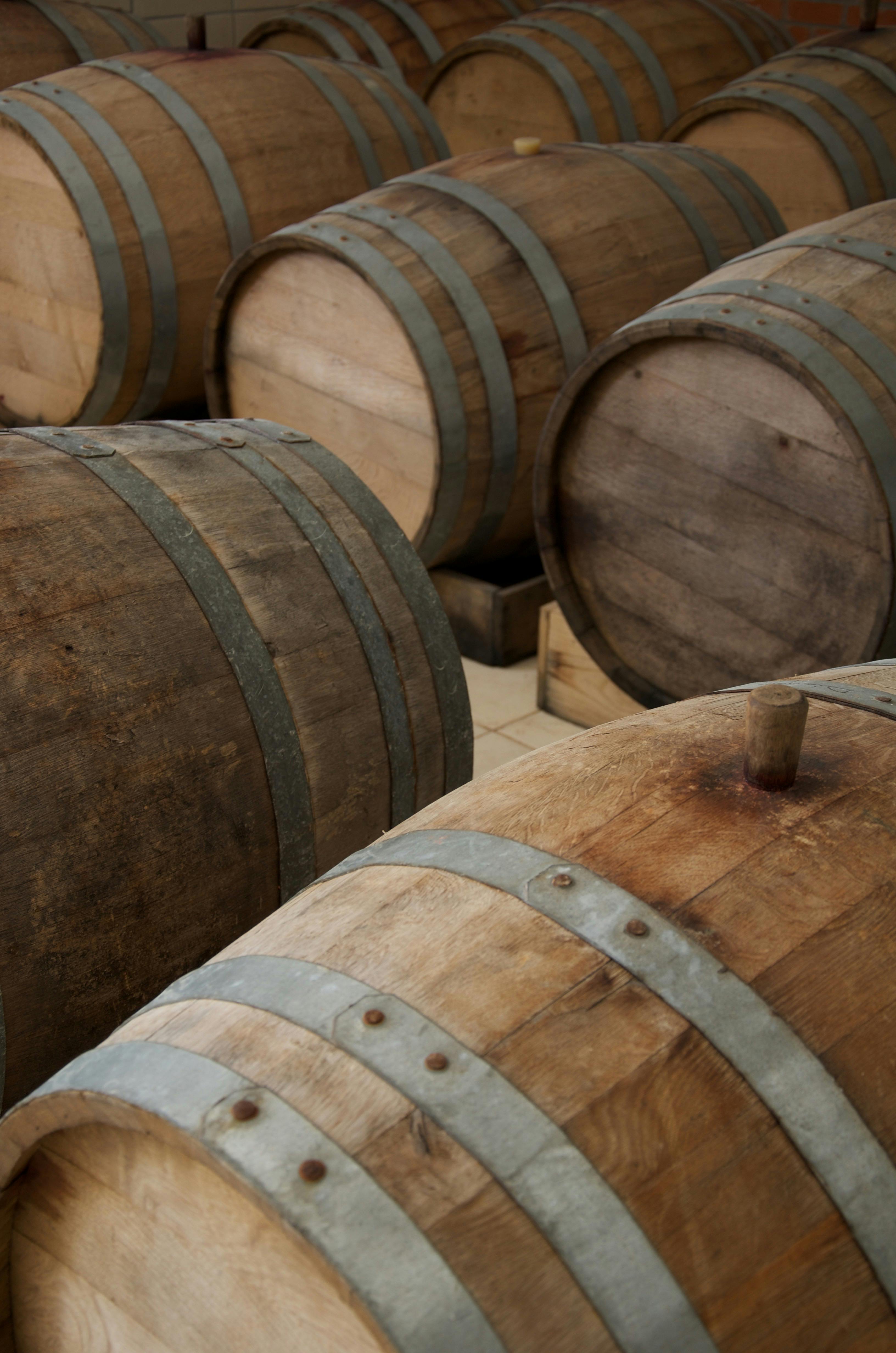 A close-up view of wooden wine barrels stored in a Tepeköy warehouse, capturing their rustic texture.