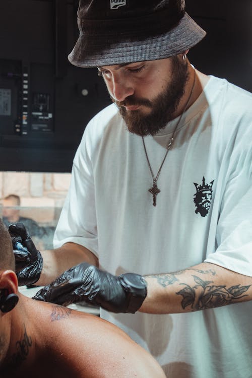 Tattooer in Hat and T-shirt