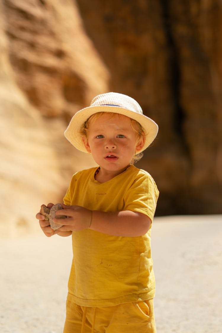 Little Child Playing With Stones In The Ruins Of The Ancient City Of Petra In Jordan