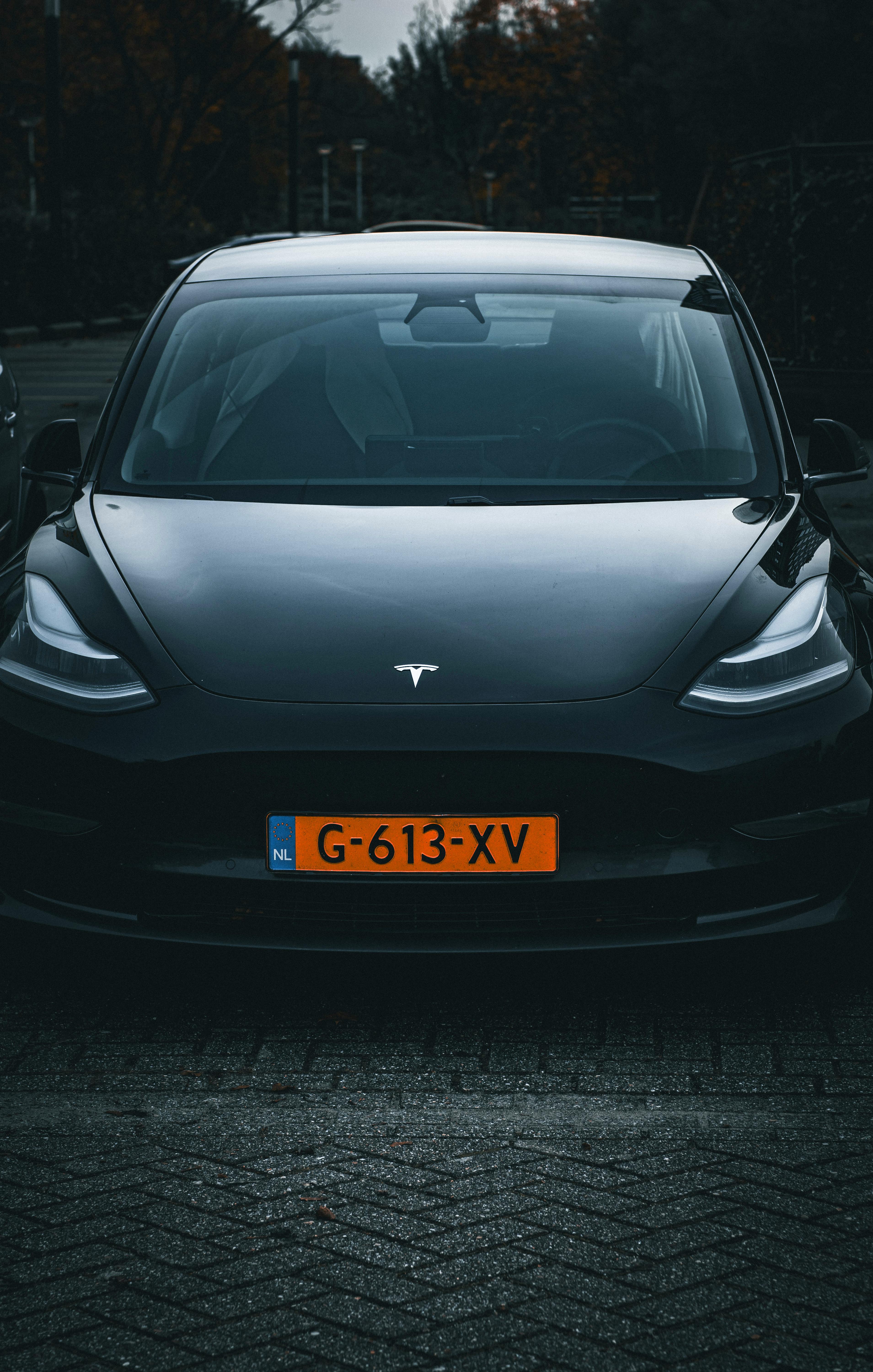 Front view of a sleek Tesla Model Y electric car parked in Amsterdam.