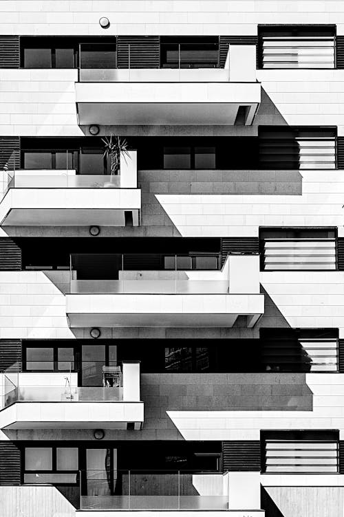Black and White Photo of a Modern Apartment Building Exterior 