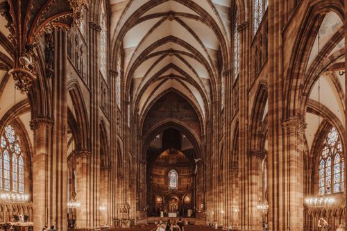 Free Beautiful view of Strasbourg Cathedral's gothic architecture with stained glass and arches. Stock Photo