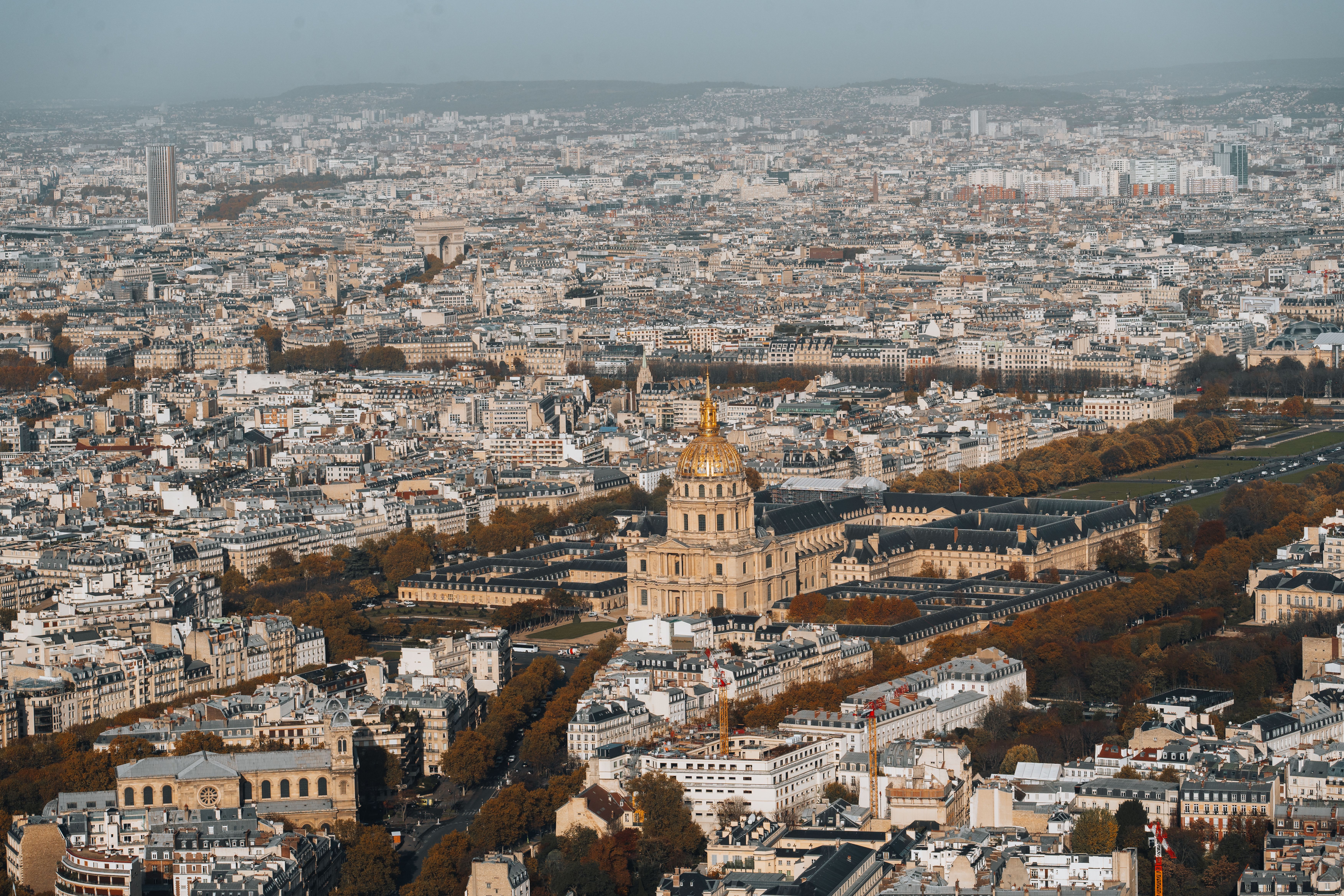 Stunning aerial view of the iconic Hôtel des Invalides surrounded by Paris cityscape.