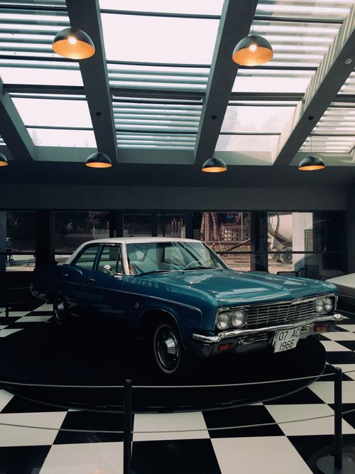 Free Classic blue Chevrolet Biscayne displayed indoors on a checkered floor. Stock Photo