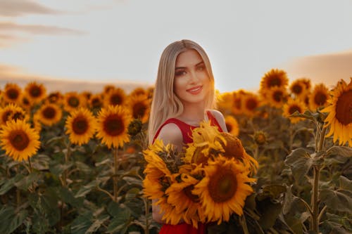 A Woman with Sunflowers at Sunset 