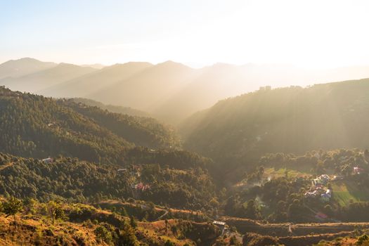 A stunning aerial view of hills and forests at sunset, showcasing nature's beauty.