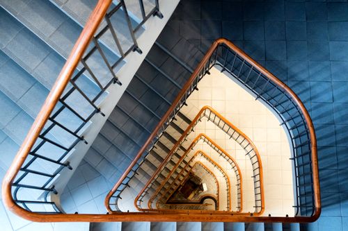 Free Top-down view of a modern spiral staircase with wooden handrails in Hamburg. Stock Photo