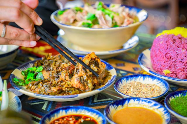 A vibrant Vietnamese meal featuring traditional dishes and chopsticks in an authentic setting.