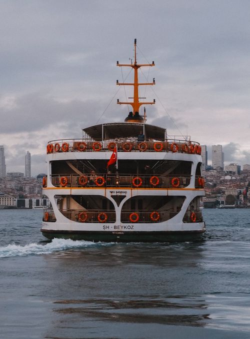 Free Ferry crossing the Bosphorus in Istanbul with city skyline in the background. Stock Photo