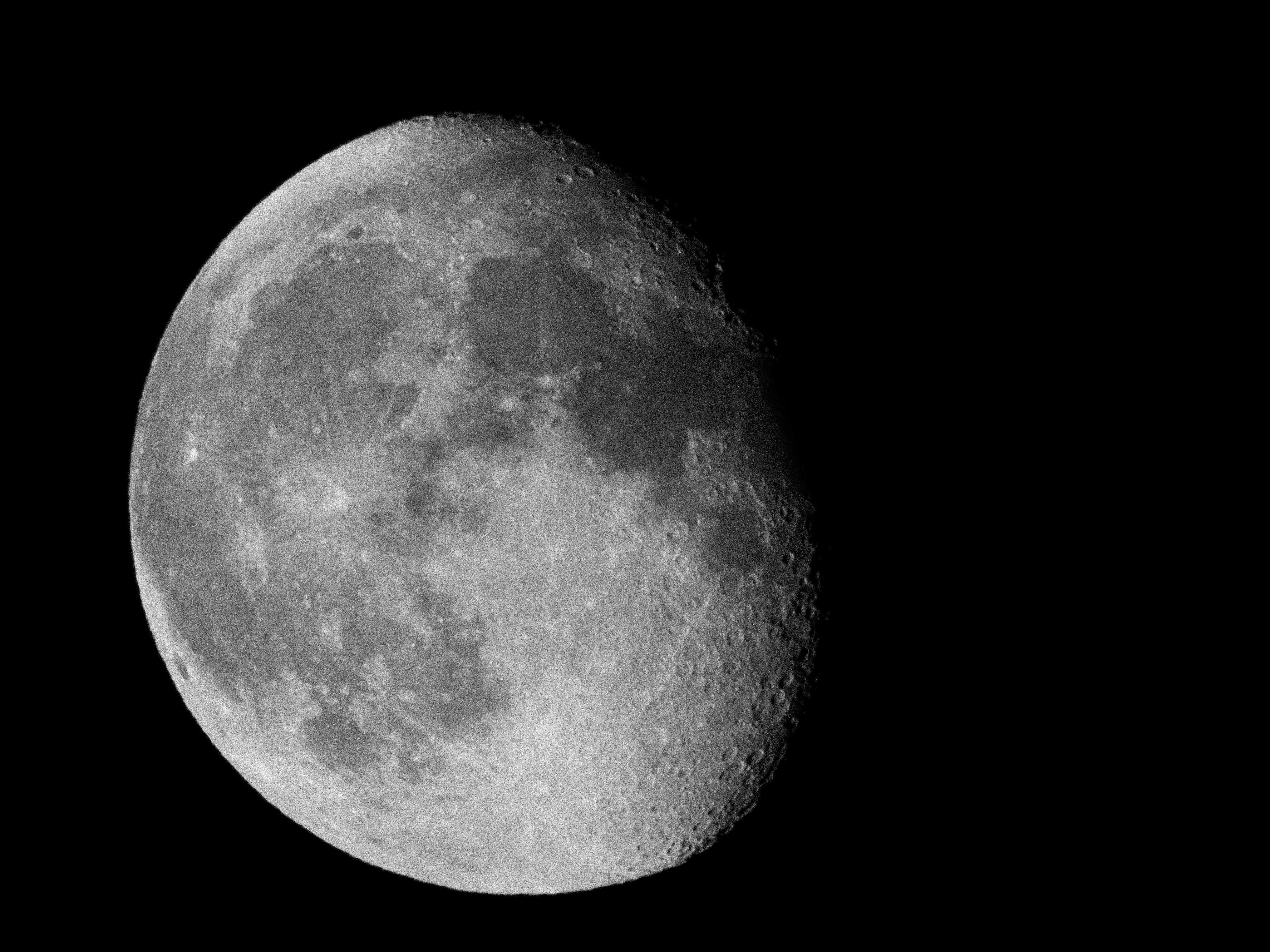 High-resolution black and white close-up of the crescent moon in night sky.