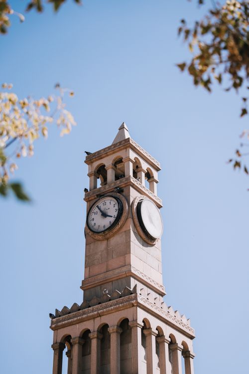 Free Low angle view of Ankara's iconic clock tower against a bright blue sky. Stock Photo