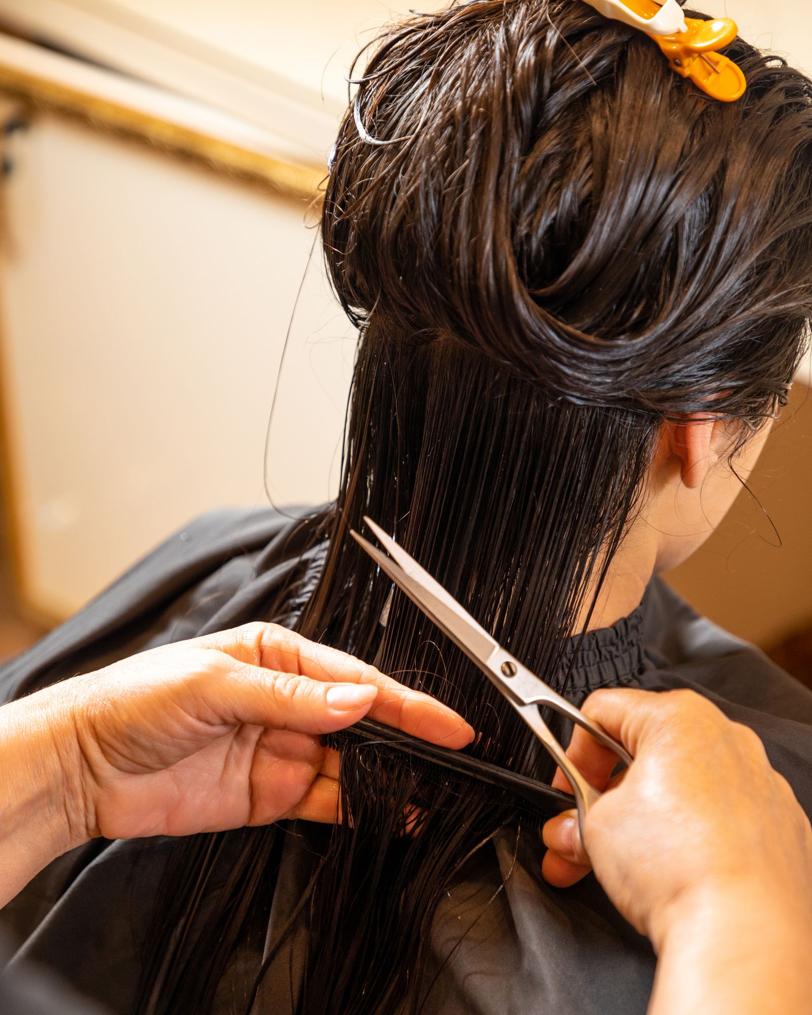 Hairstylist giving a client a precision haircut at SM Threading & Salon