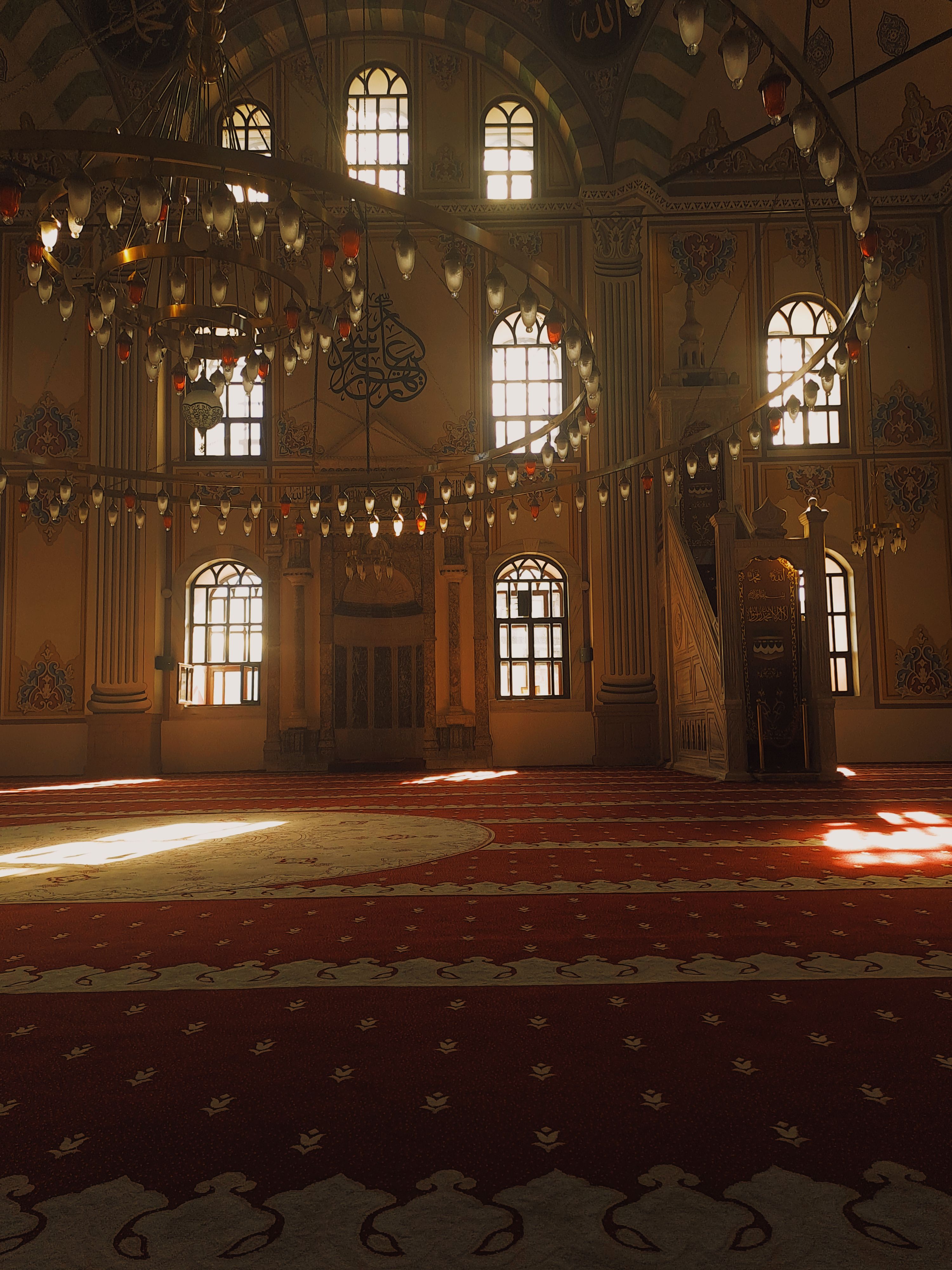 Mosque Interior with a Chandelier and a Red Carpet · Free Stock Photo