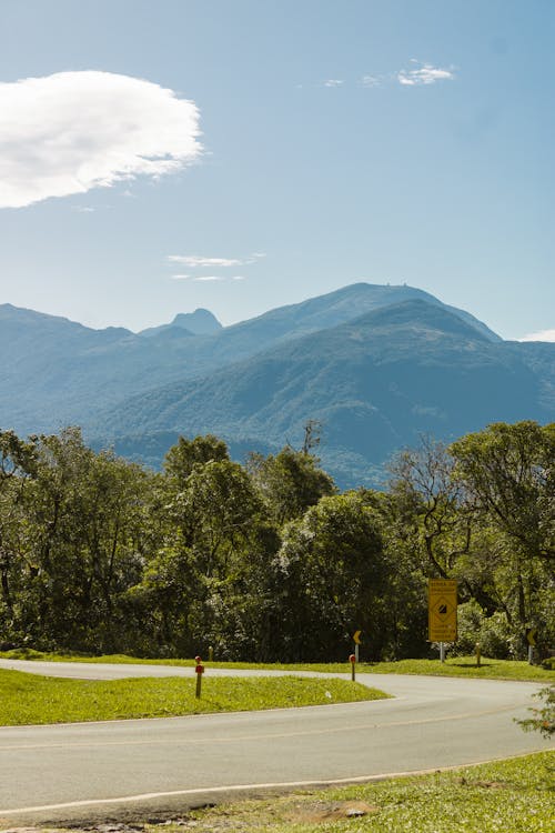 Curve on Road with Green Mountains in Background