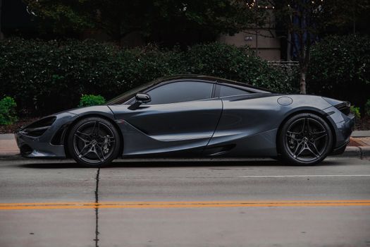 Elegant sports car with modern design parked on a city street, showcasing luxury and style.