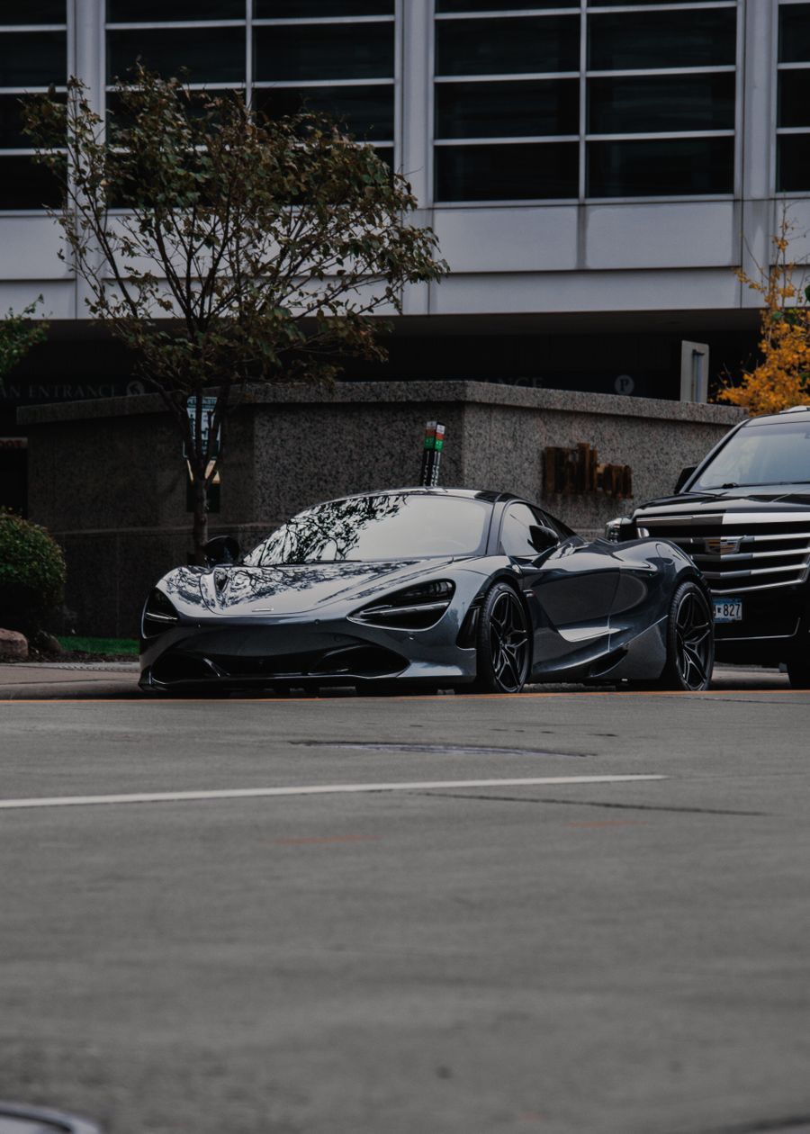 BMW M4 Competition, black sports car on a city street
