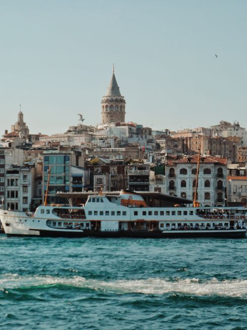 Free Explore Istanbul's skyline featuring the iconic Galata Tower and bustling waterfront scene. Stock Photo