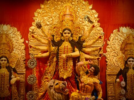 Magnificent statue of Goddess Durga adorned in gold during a religious festival in Kolkata, India.
