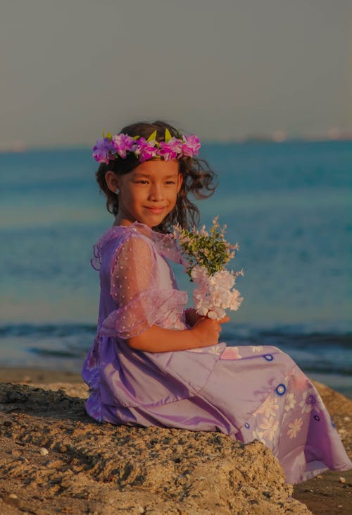 Little Girl Wearing Purple Dress on a Beach 